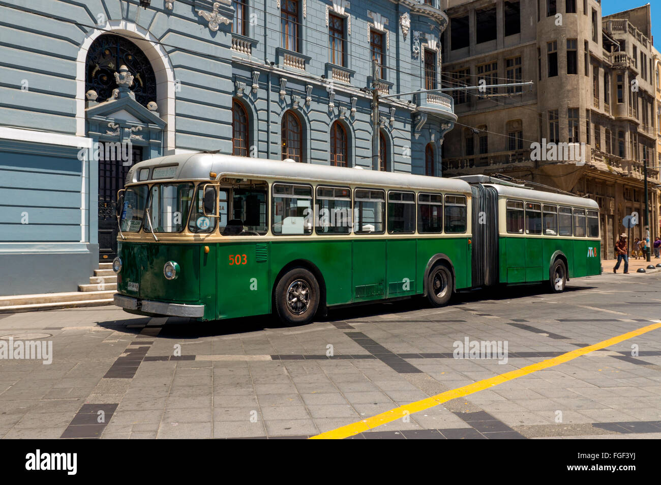 Historic trolleybus beside Valparaíso architecture