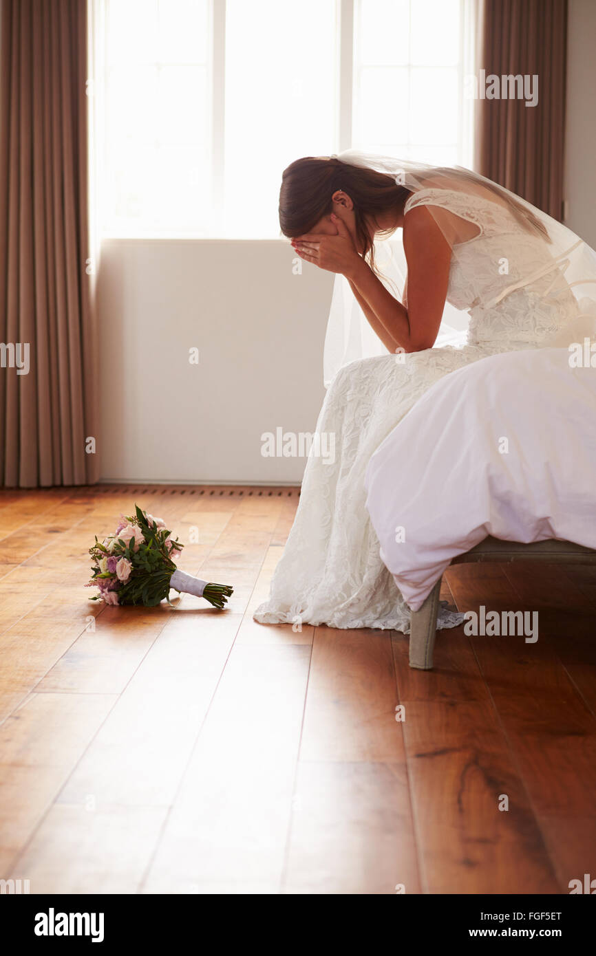 Bride In Bedroom Having Second Thoughts Before Wedding Stock Photo