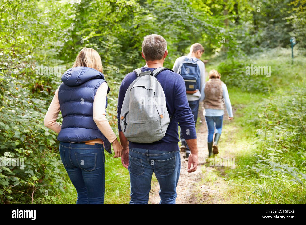 Family On Walk Through Beautiful Countryside Stock Photo