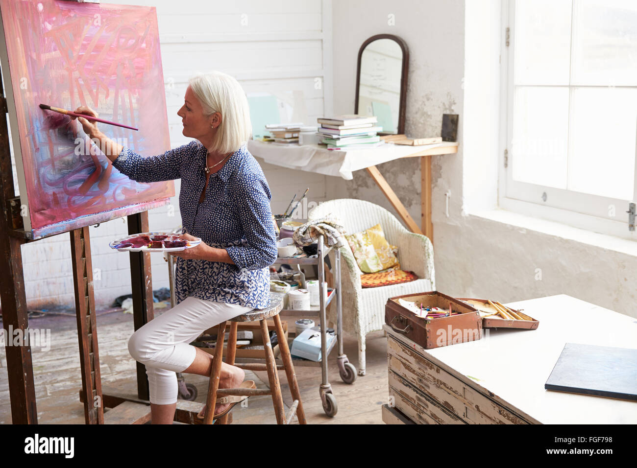 Female Artist Working On Painting In Studio Stock Photo - Alamy