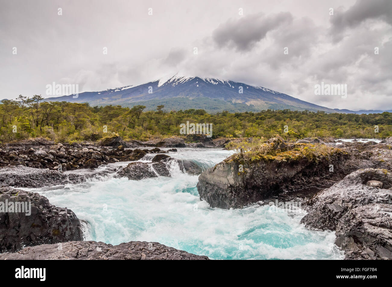 The Petrohue Falls and Osorno Volcano with its snow peak in Puerto Varas in cloudy weather
