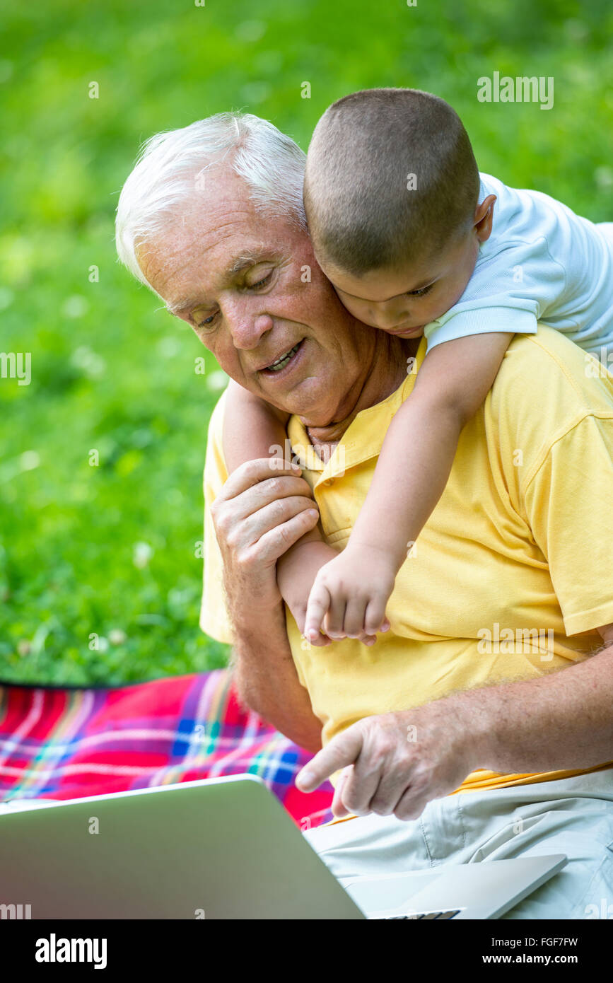 grandfather and child using laptop Stock Photo