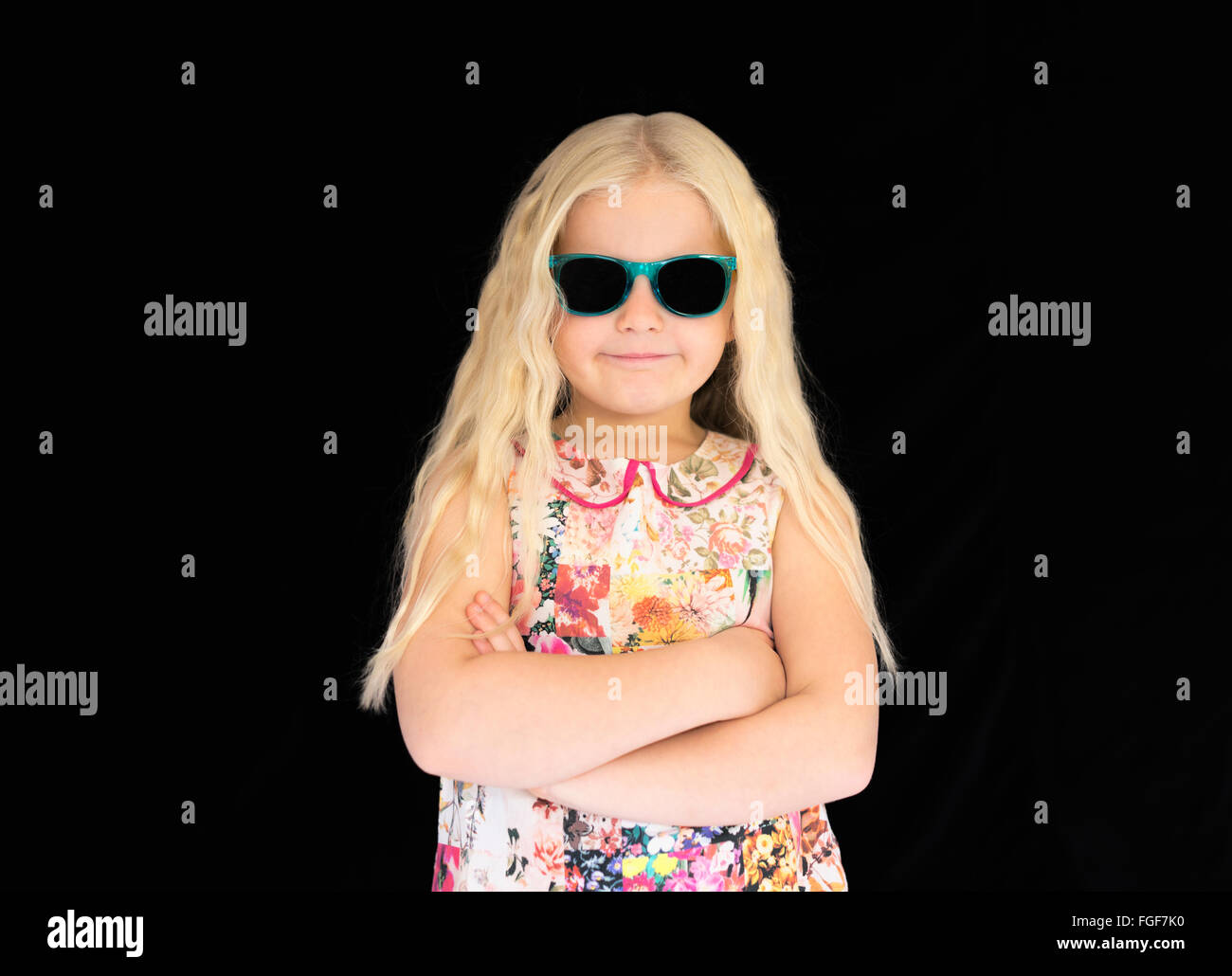 Young girl with long blonde hair wearing sunglasses, smiling Stock Photo
