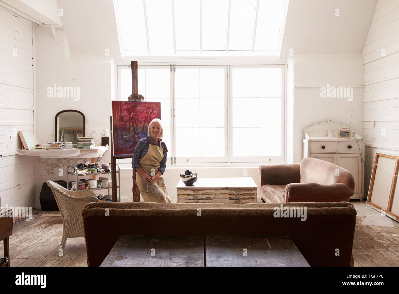 Female Artist Working On Painting In Bright Daylight Studio Stock Photo ...