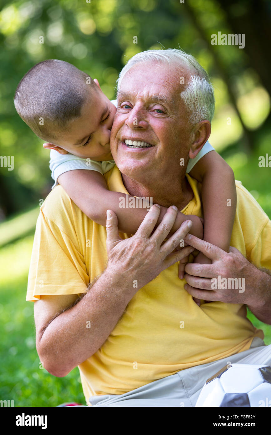 grandfather and child have fun  in park Stock Photo