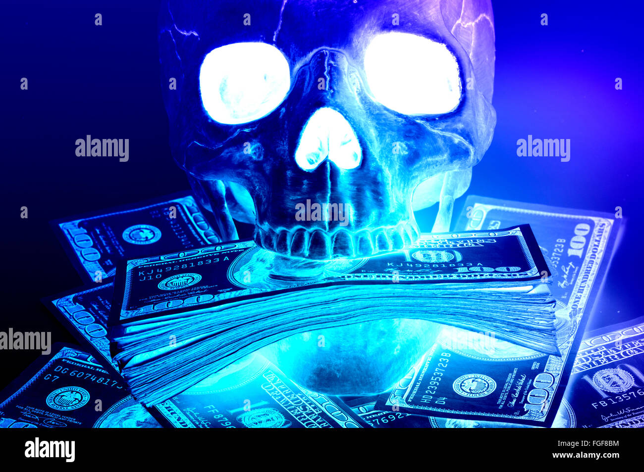 closeup skull with money stuffed in mouth abstract Stock Photo