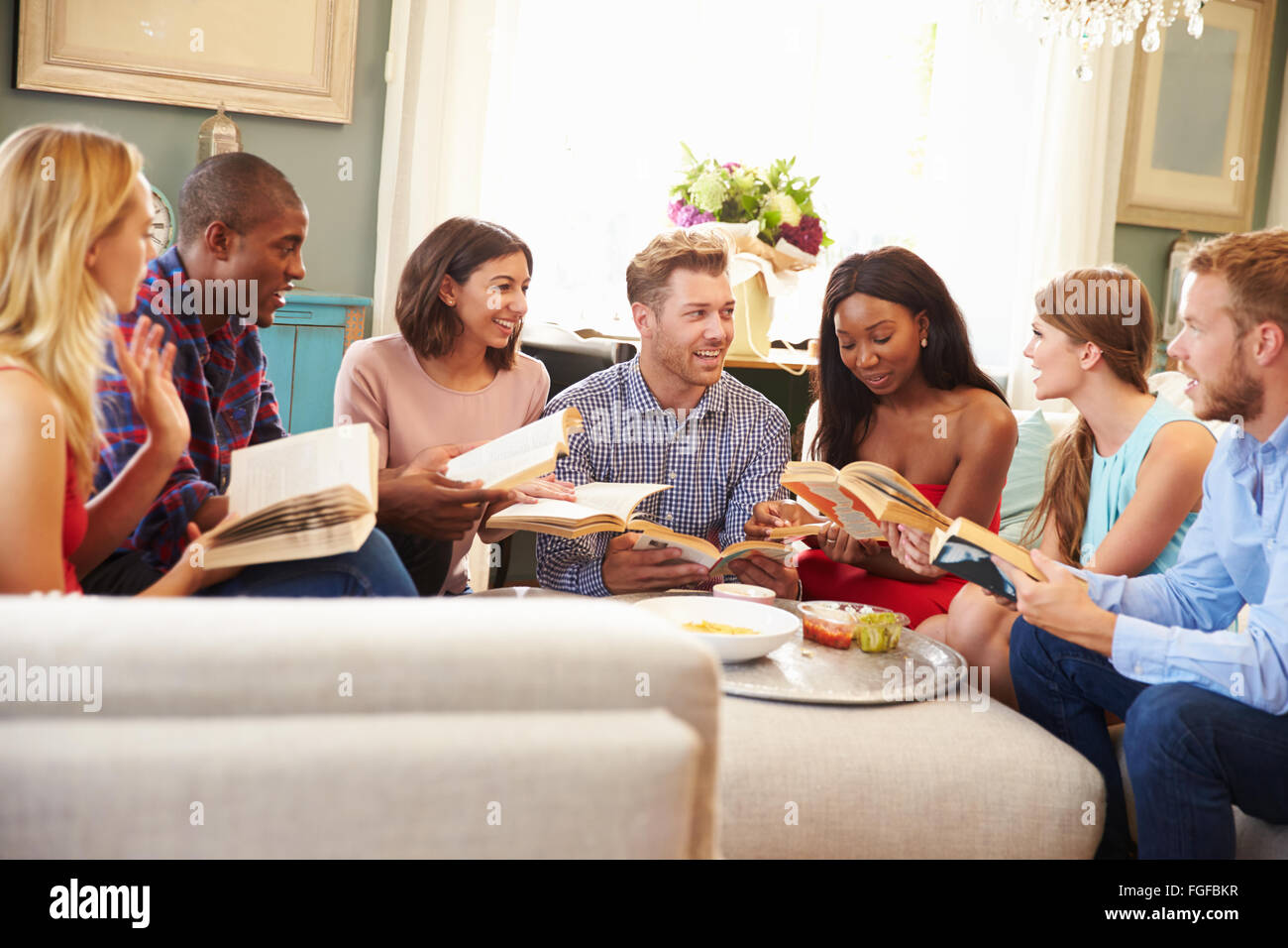 Group Of Friends Taking Part In Book Club At Home Stock Photo Alamy