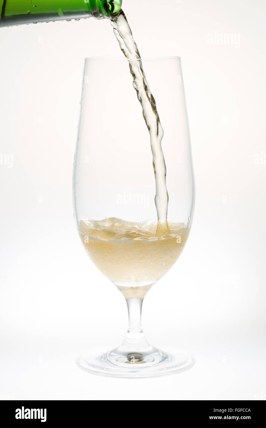 Beer Pouring from Bottle into Glass on white background Stock Photo Alamy
