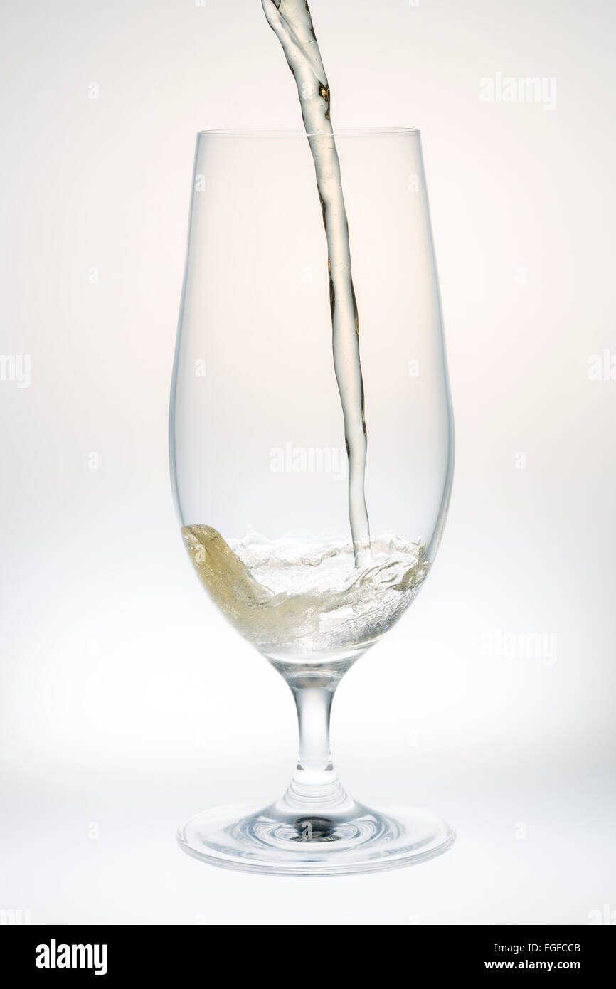 Beer Pouring into Glass close up Stock Photo
