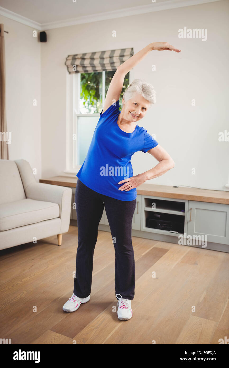 Senior woman performing stretching exercise Stock Photo - Alamy