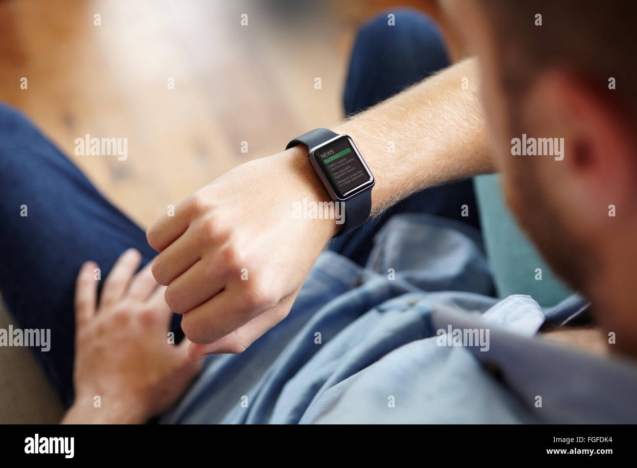 Man Looking At News Application Software On Smart Watch Stock Photo