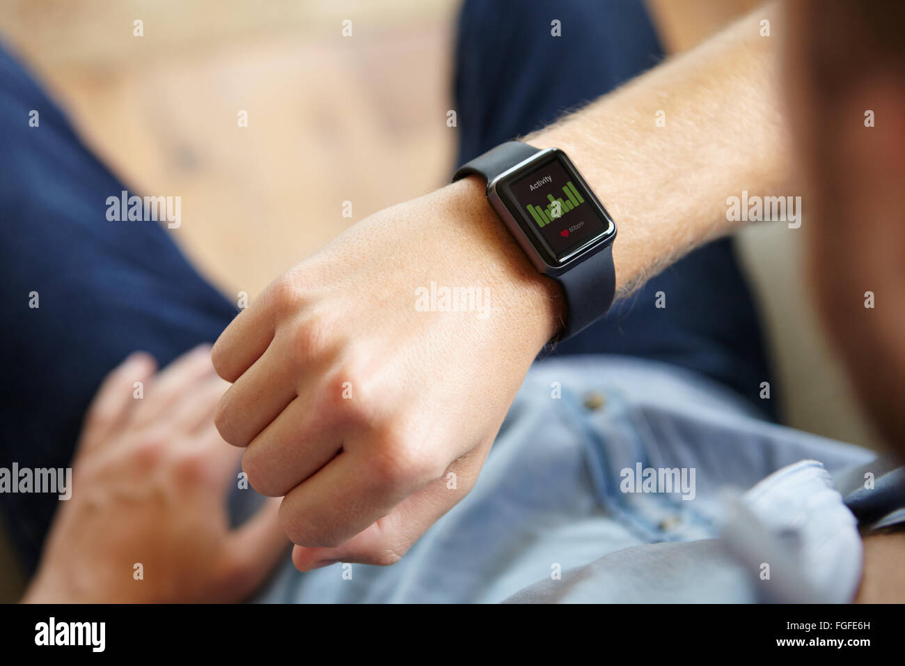 Man Looking At Health Application Software On Smart Watch Stock Photo