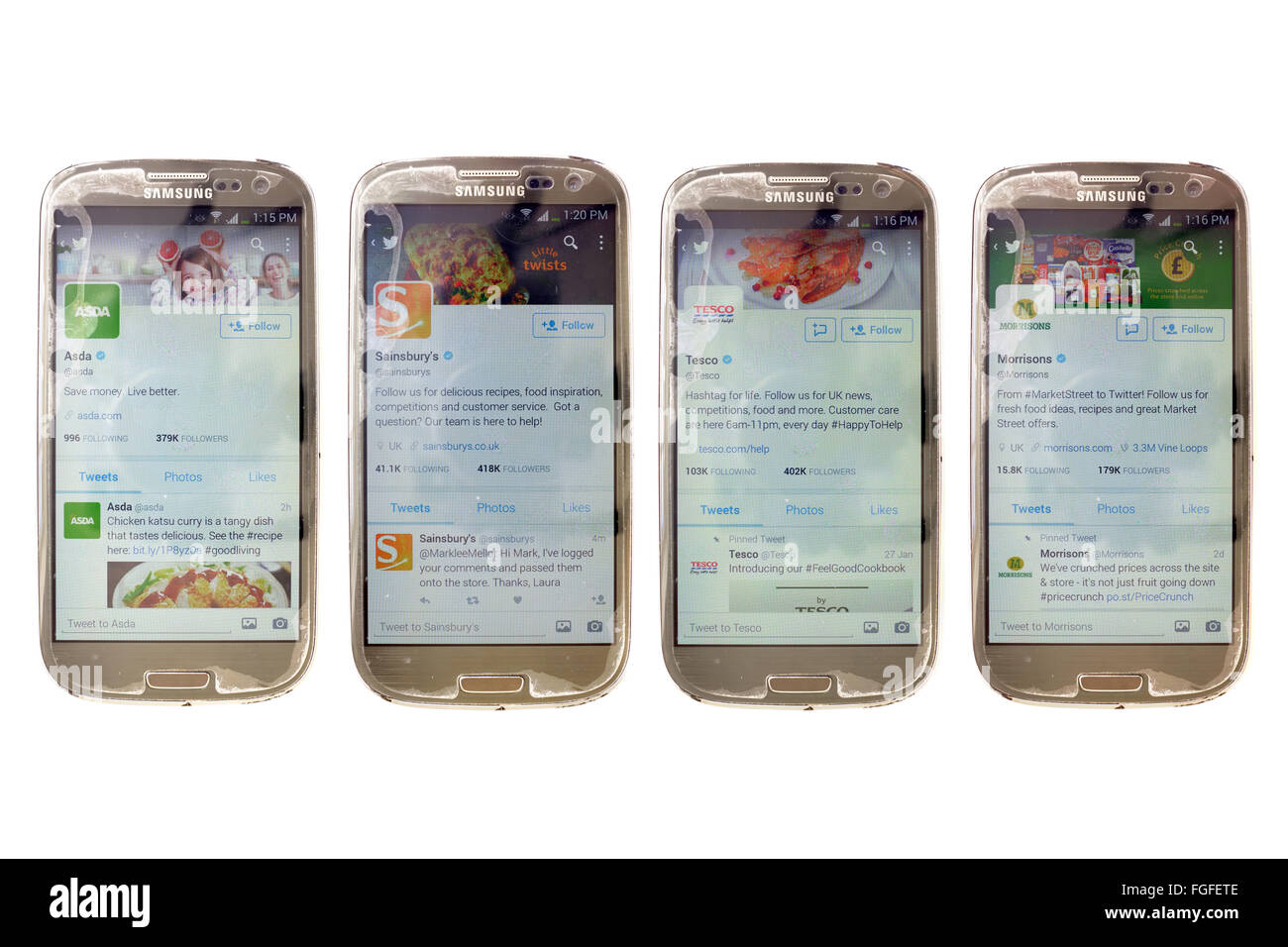 Supermarket Twitter accounts on smartphone screens photographed against a white background. Stock Photo