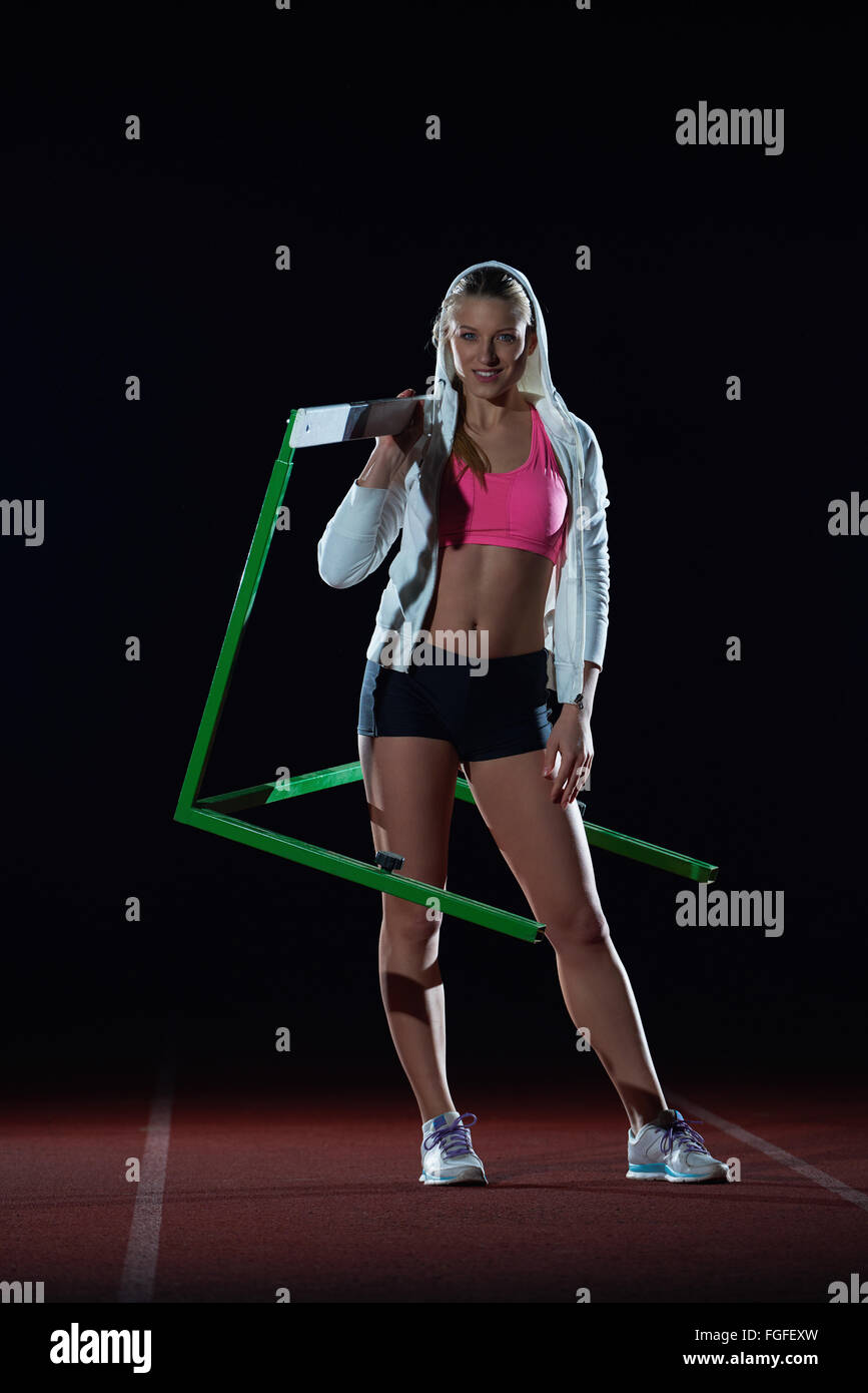 woman athlete jumping over a hurdles Stock Photo - Alamy