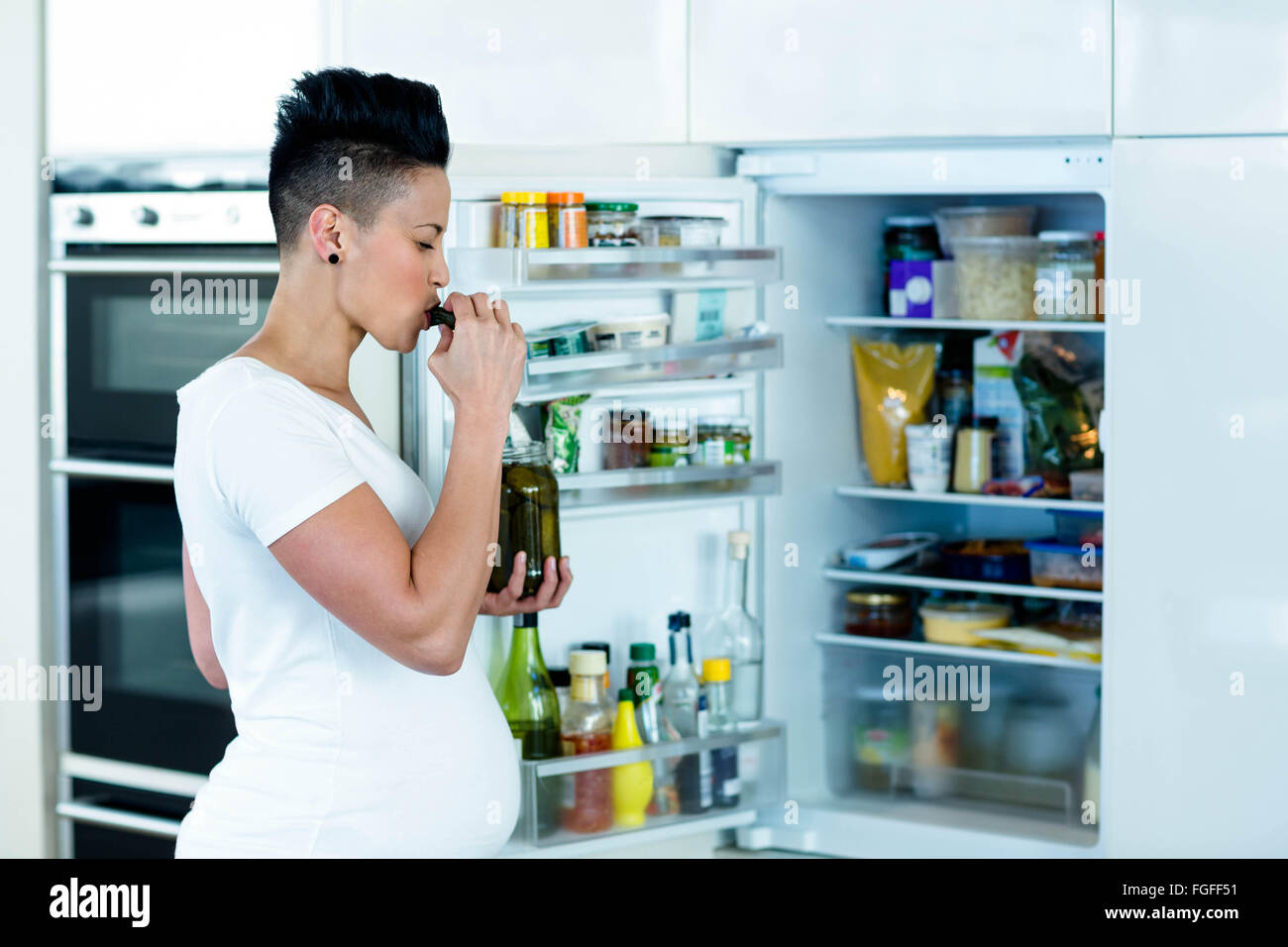 Pregnant woman eating pickles Stock Photo Alamy