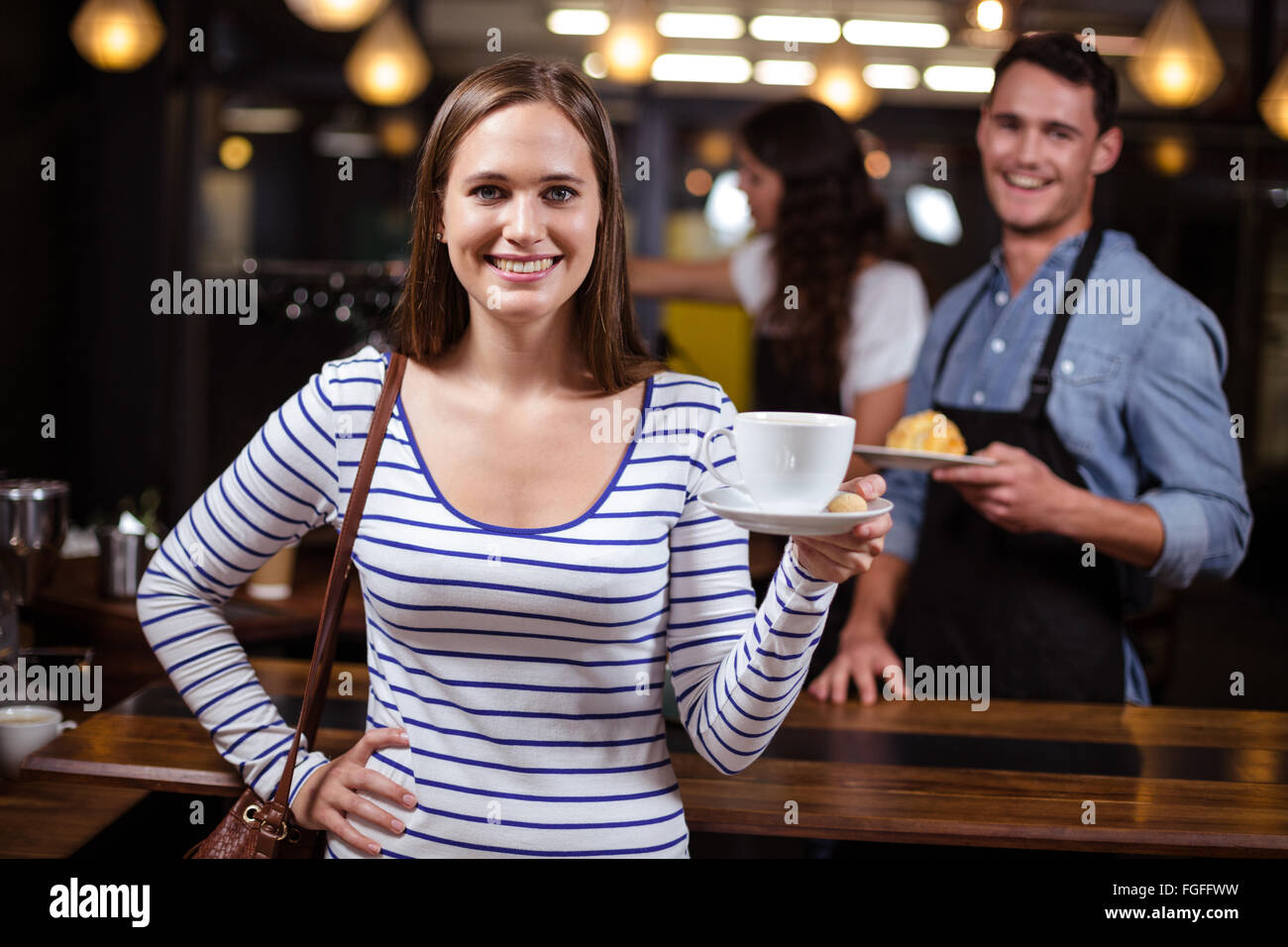 Smiling woman holding white cup Stock Photo