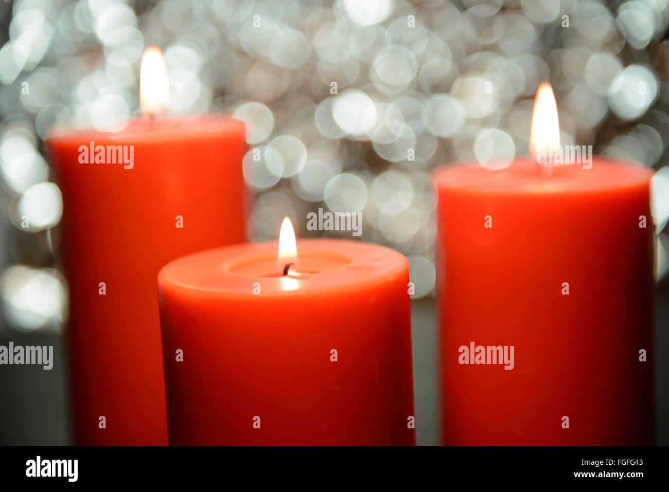 three big aromatic candle light up in front of beautiful bokeh background, valentine's day Stock Photo