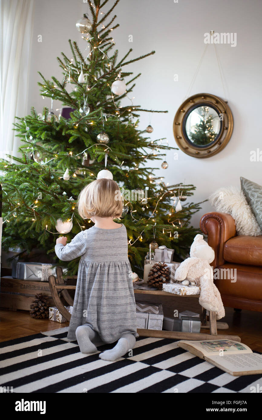 Girl By Christmas Tree Stock Photo - Alamy
