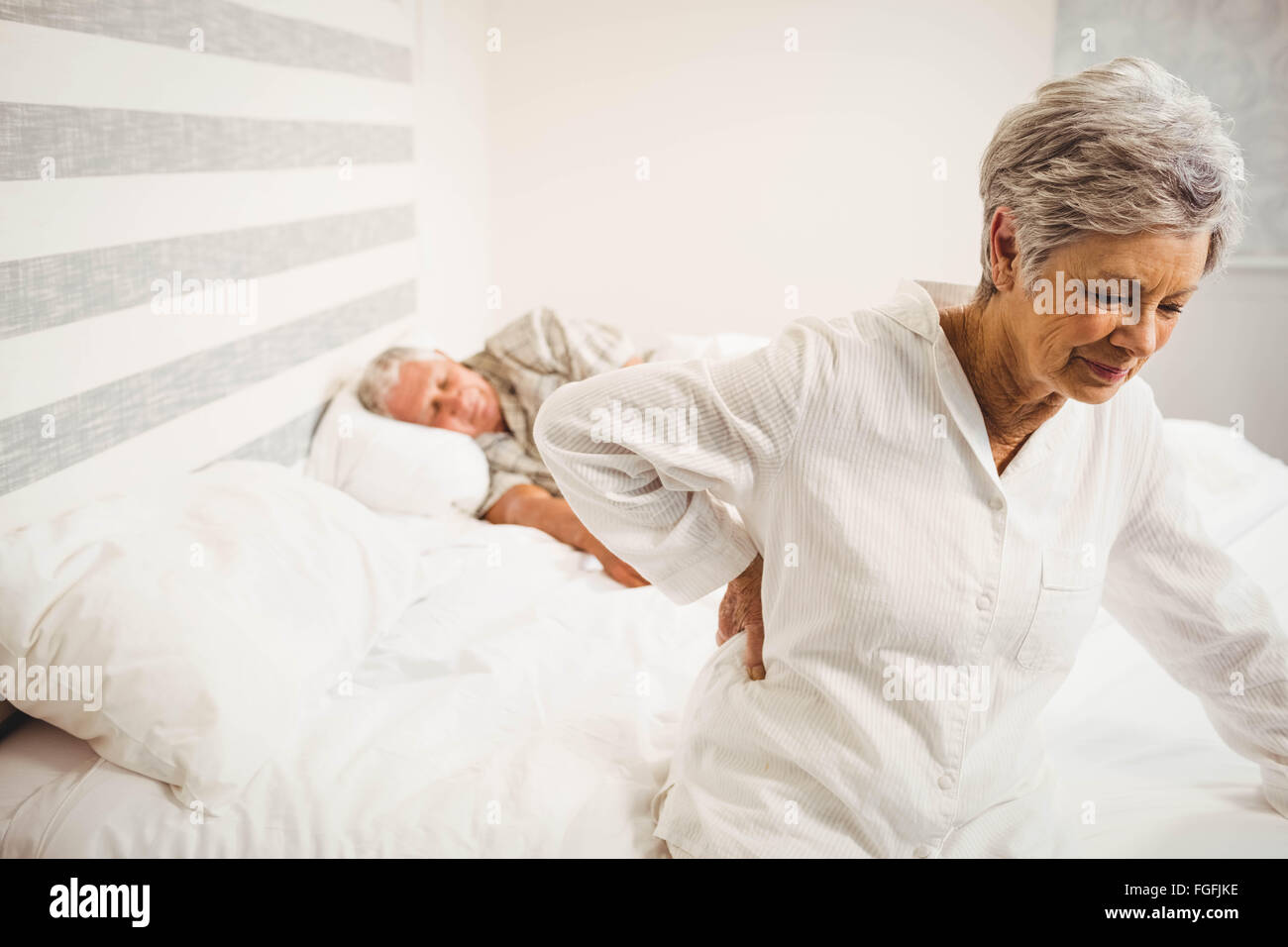 Senior woman suffering from backache sitting on bed Stock Photo Alamy