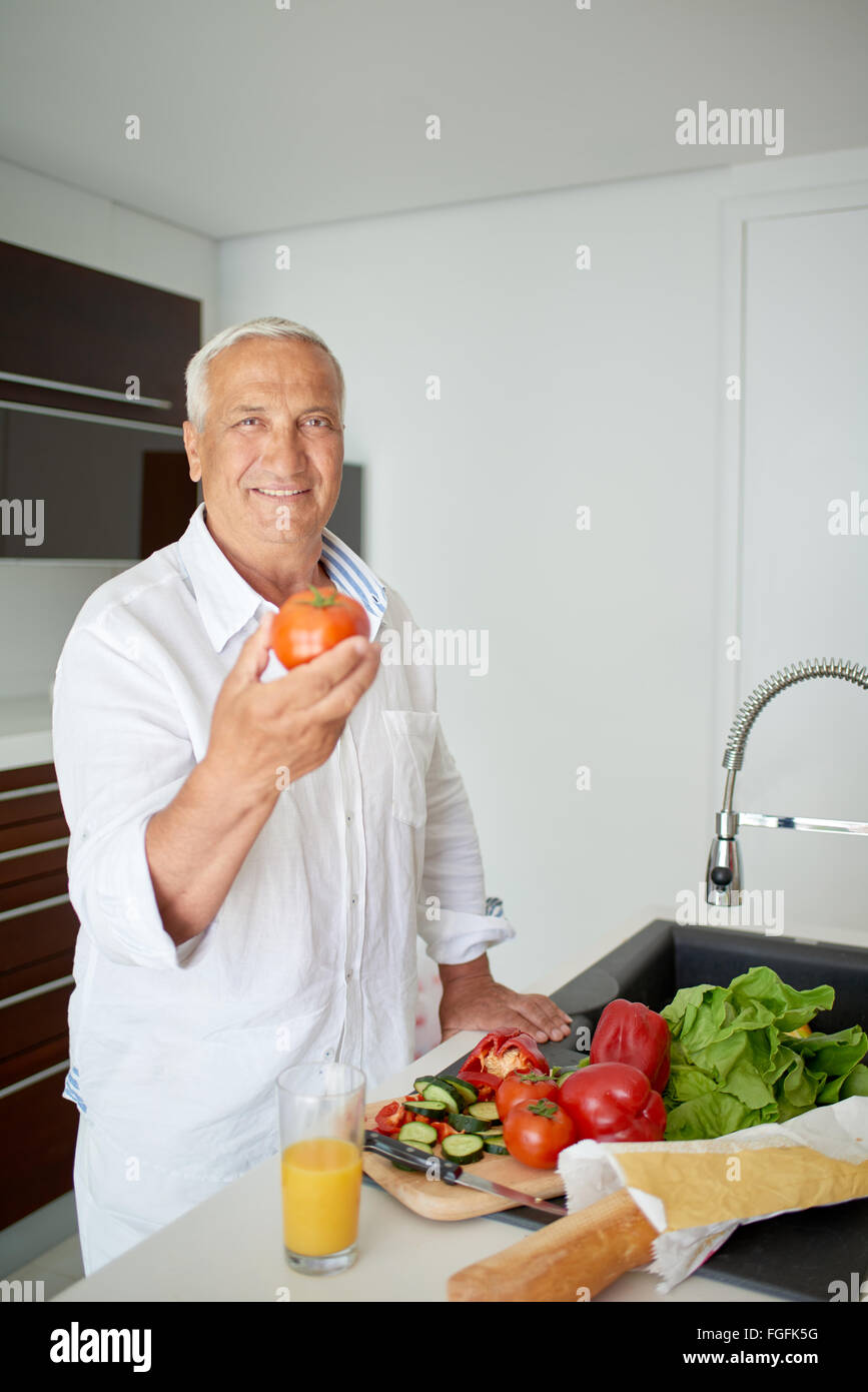 man cooking at home preparing salad in kitchen Stock Photo Alamy