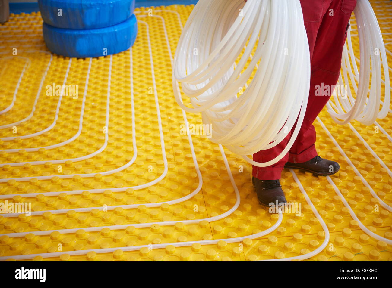 workers installing underfloor heating system Stock Photo Alamy