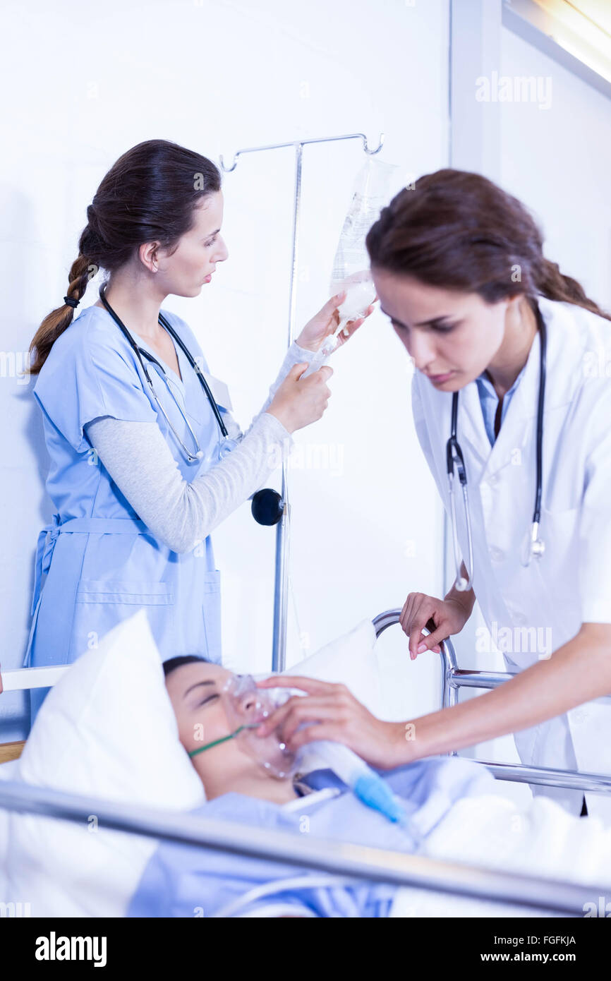 Doctors putting an oxygen mask on patient Stock Photo Alamy