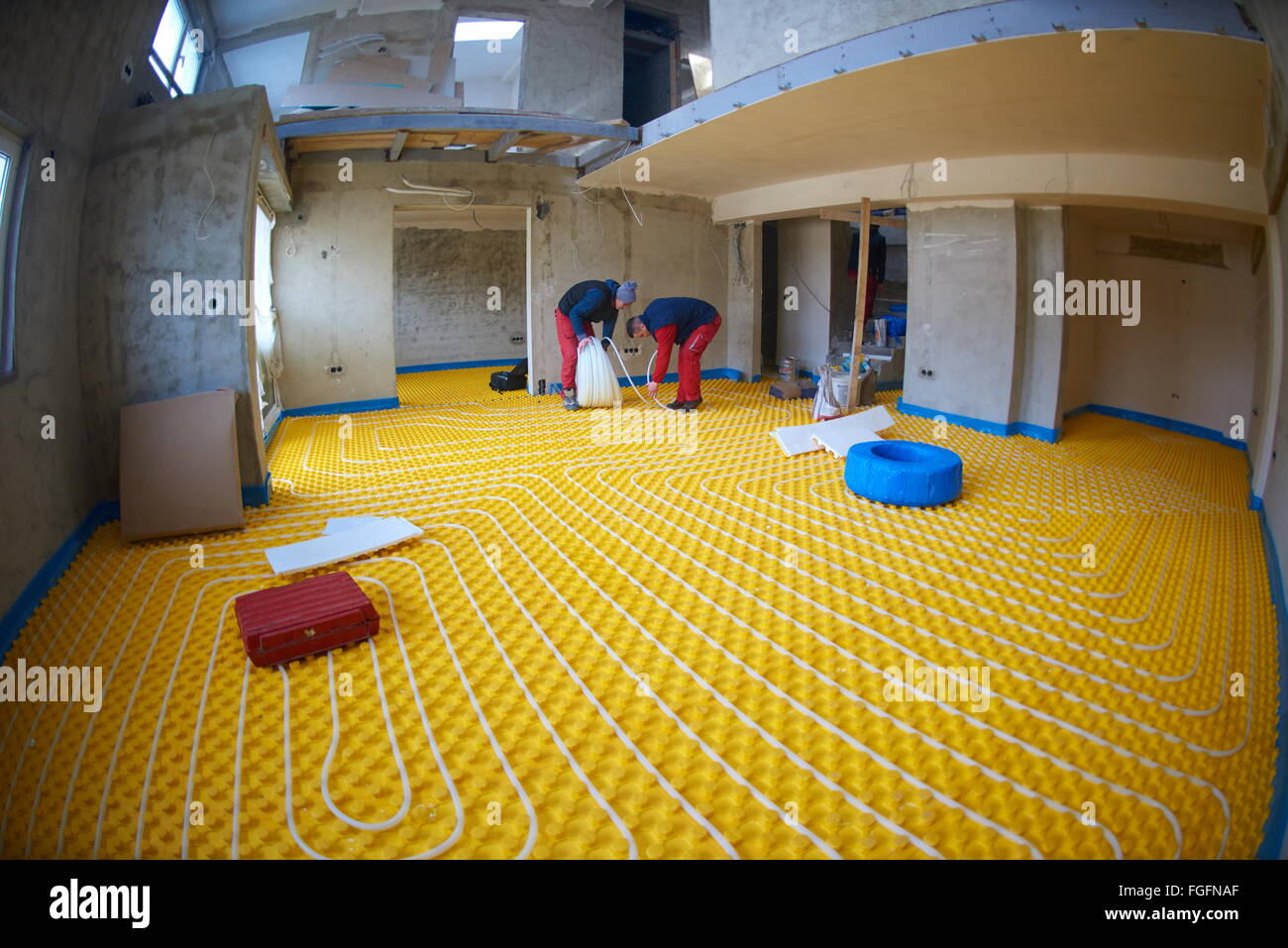 workers installing underfloor heating system Stock Photo Alamy
