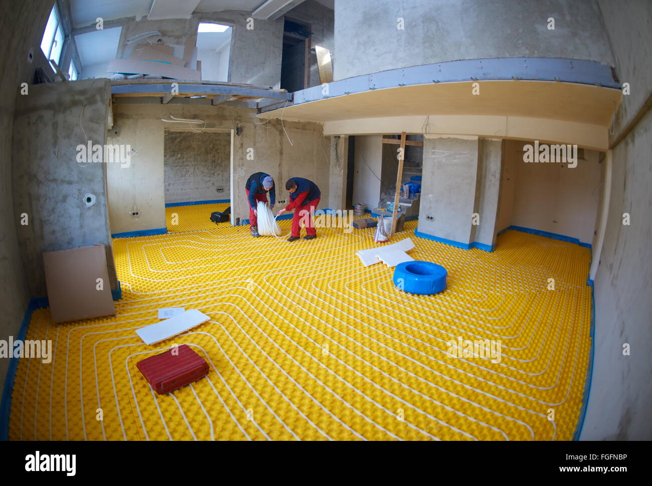 workers installing underfloor heating system Stock Photo Alamy