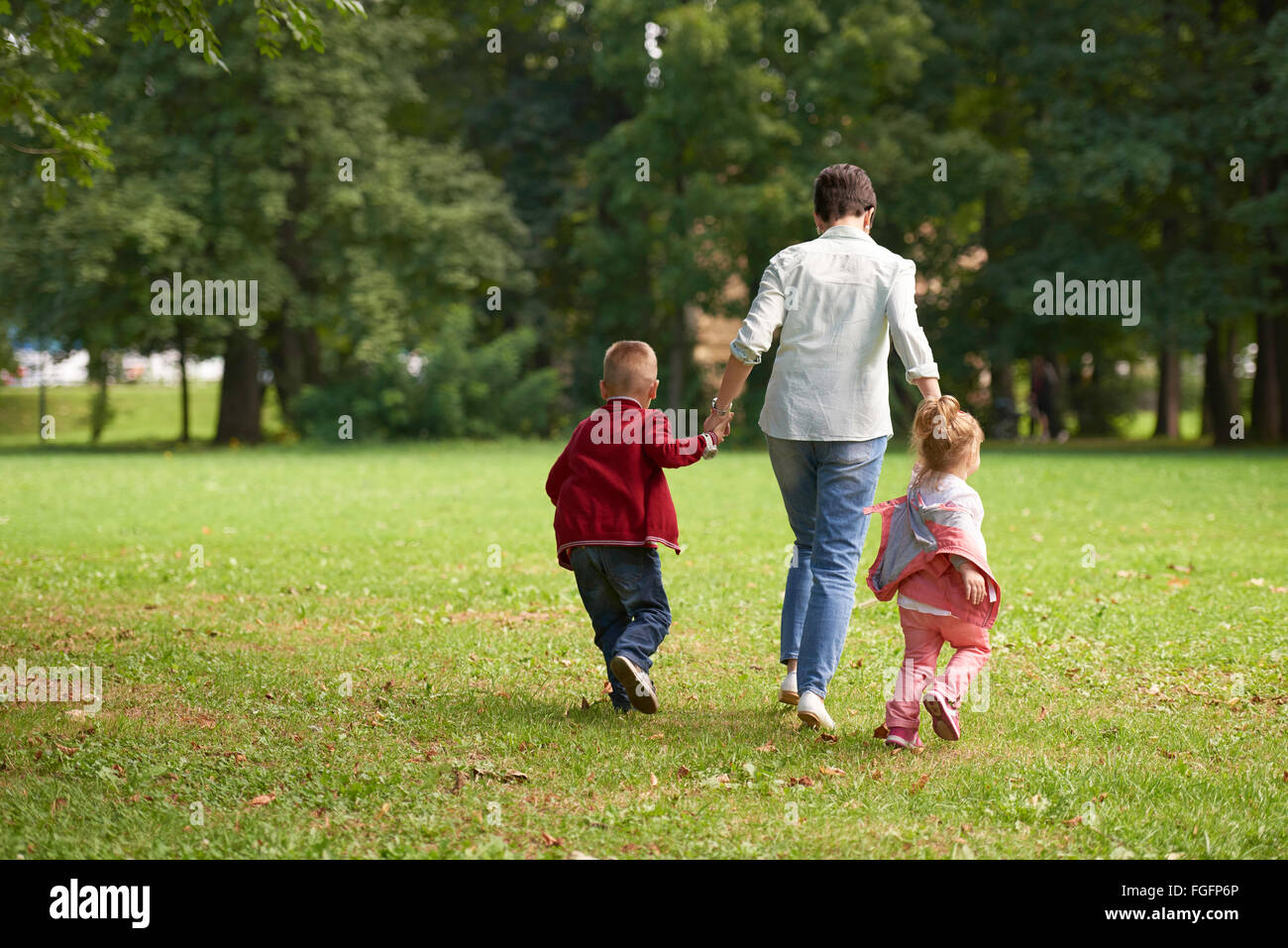 happy family playing together outdoor in park Stock Photo - Alamy