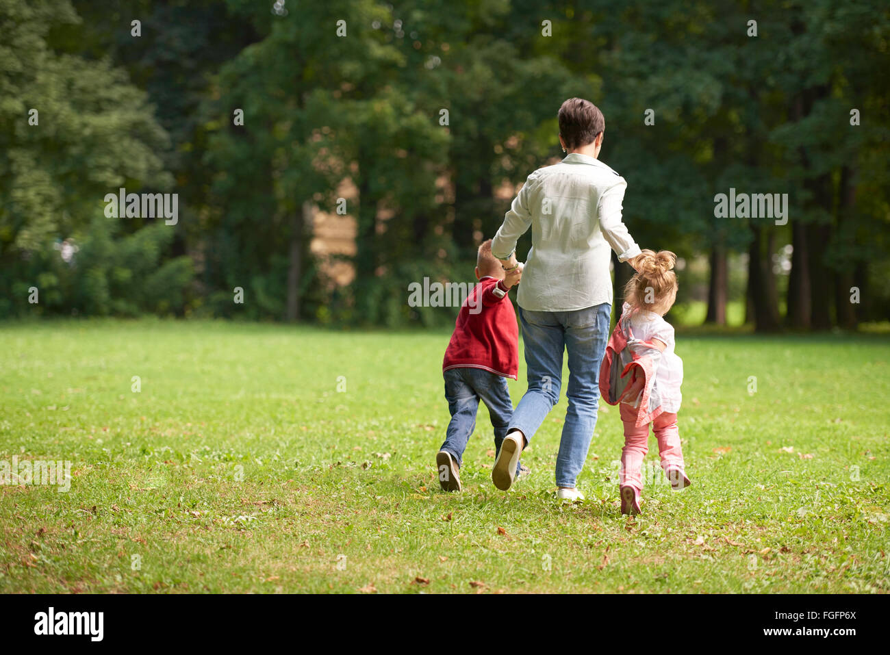 happy family playing together outdoor in park Stock Photo - Alamy