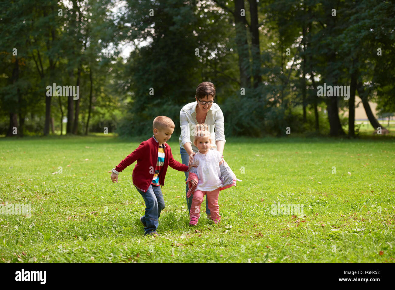 happy family playing together outdoor in park Stock Photo - Alamy