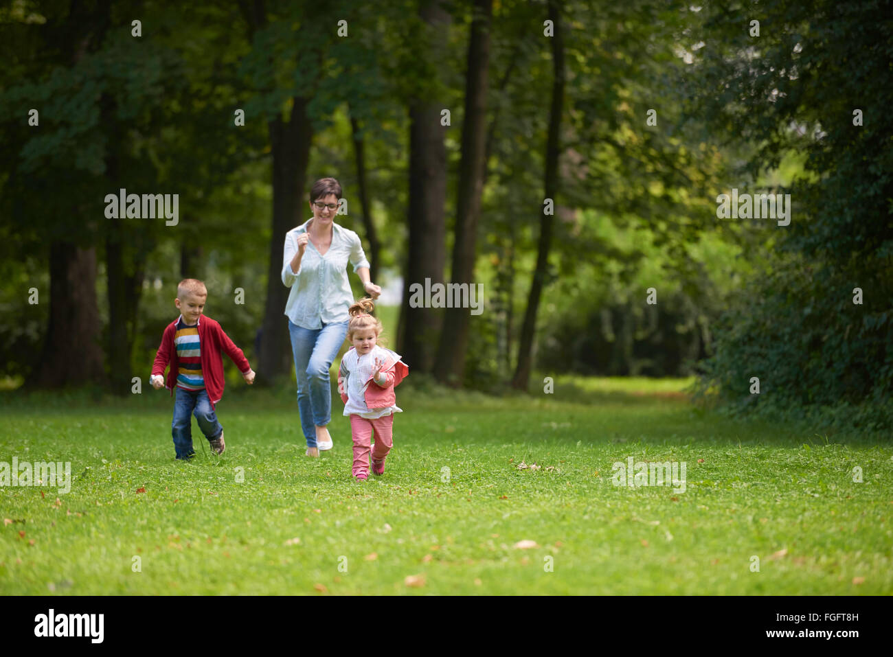 happy family playing together outdoor in park Stock Photo - Alamy