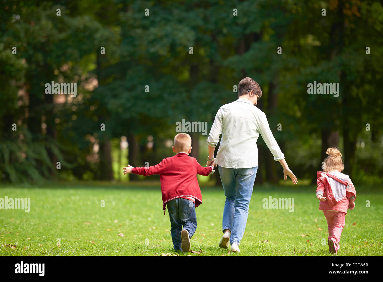 happy family playing together outdoor in park Stock Photo - Alamy