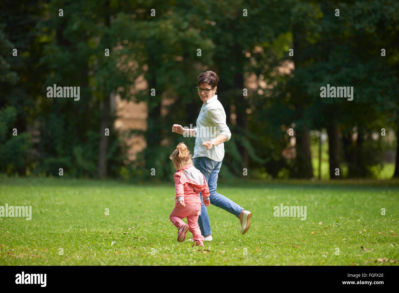 happy family playing together outdoor in park Stock Photo - Alamy