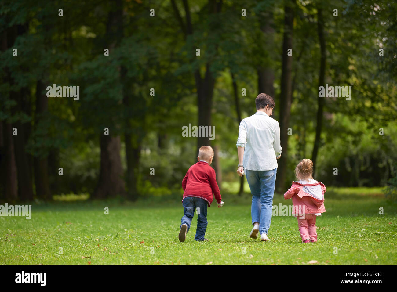 happy family playing together outdoor in park Stock Photo - Alamy