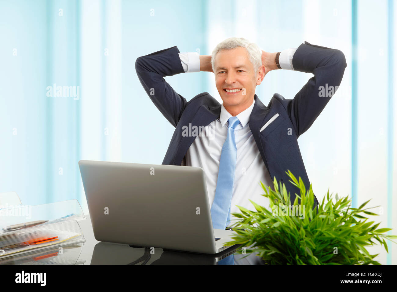 Portrait of senior businessman sit back and relaxing while sitting at office Stock Photo Alamy