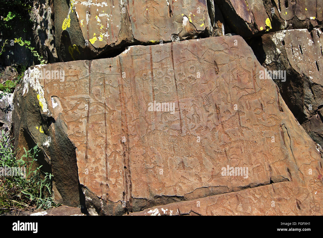 Rounded Rocks By Humans Silhouettes of people and animals carved on the rocks by primitive ...