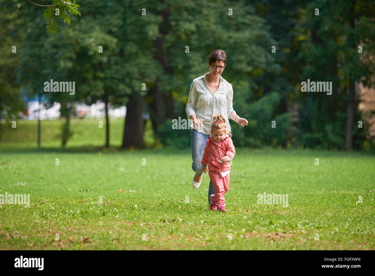 happy family playing together outdoor in park Stock Photo - Alamy