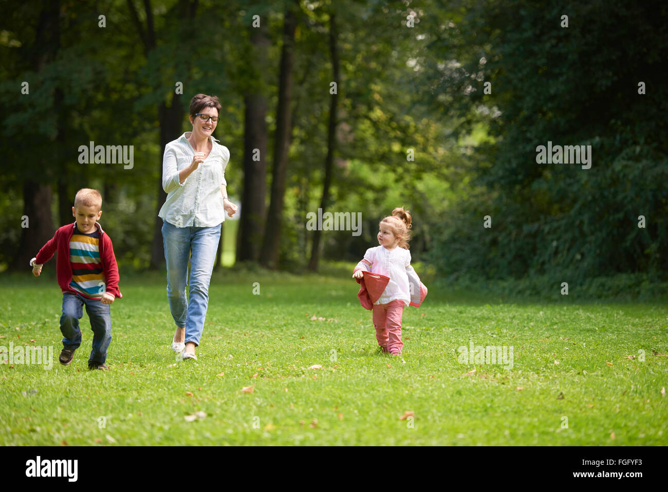 happy family playing together outdoor in park Stock Photo - Alamy