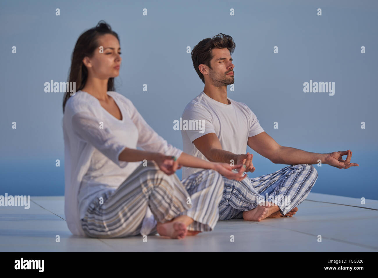 young couple practicing yoga Stock Photo