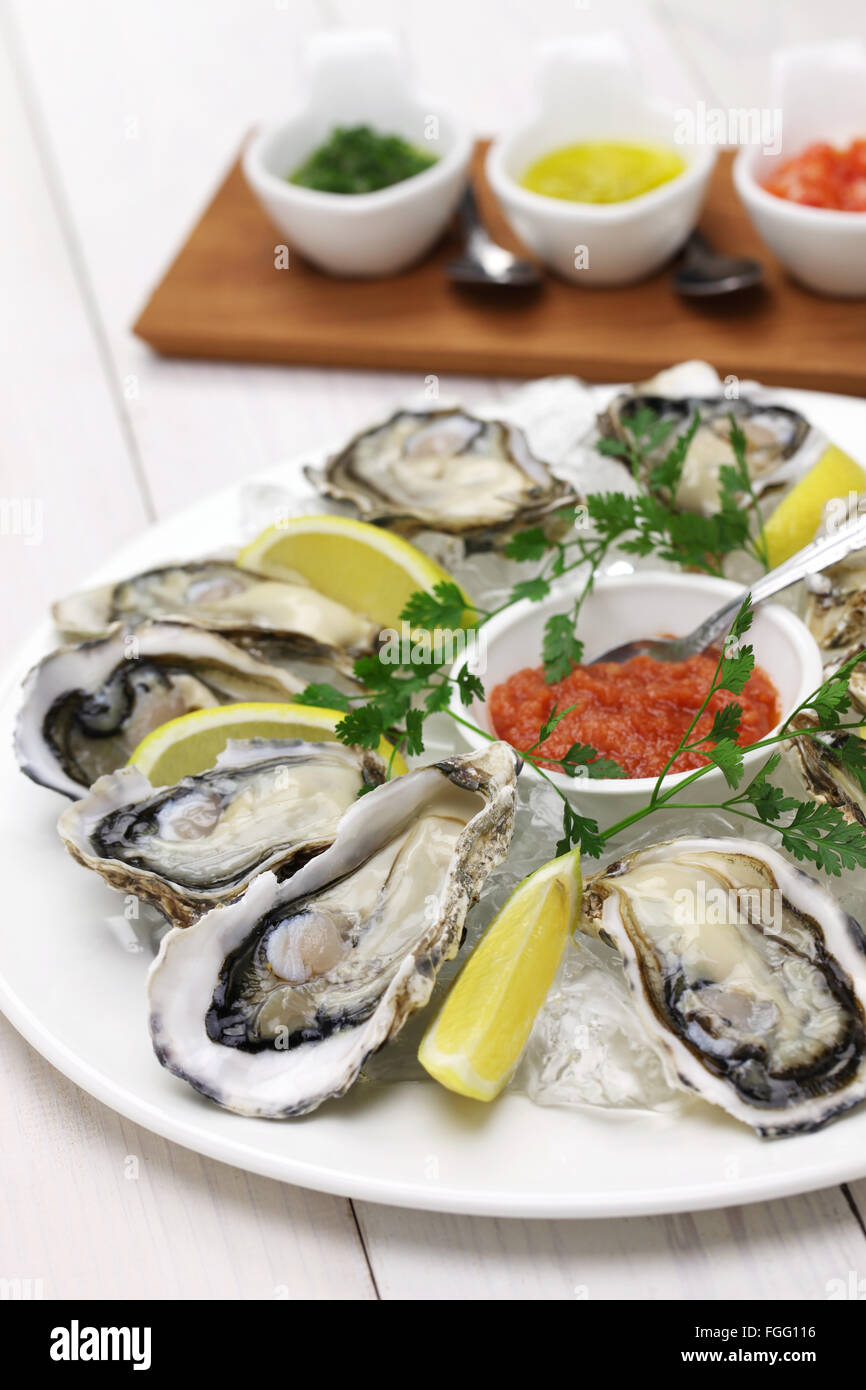 fresh oysters plate isolated on white wooden background Stock Photo