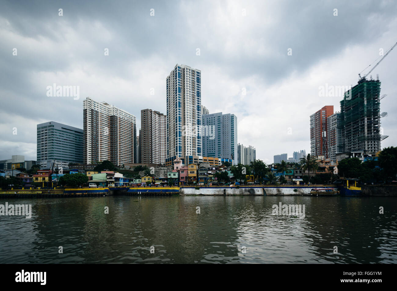 Buildings in Mandaluyong and the Pasig River, in Makati, Metro Manila, The Philippines. Stock Photo