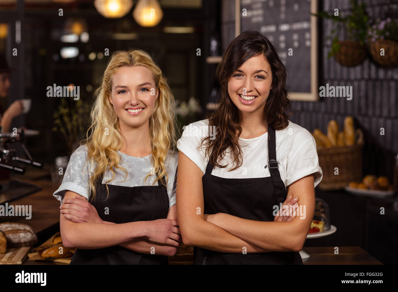 Pretty waitresses posing in front of the counter Stock Photo