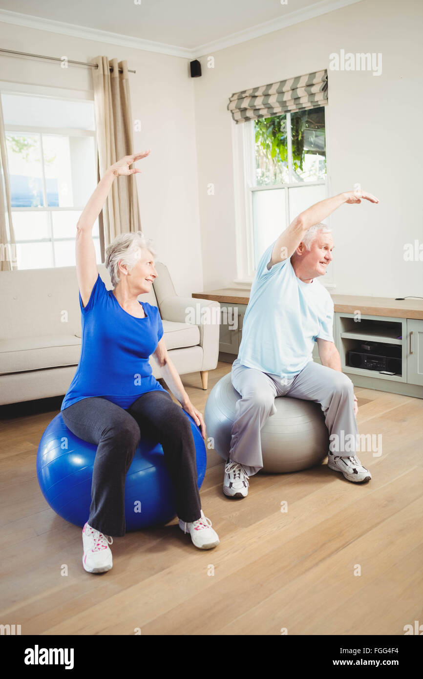 Senior couple doing stretching exercise on exercise ball Stock Photo ...