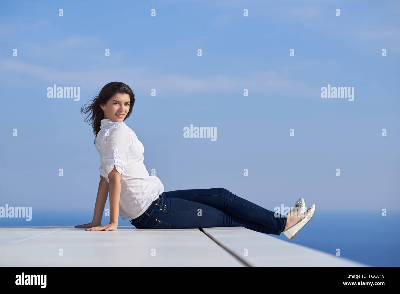 relaxed woman in front of luxury modern home Stock Photo - Alamy