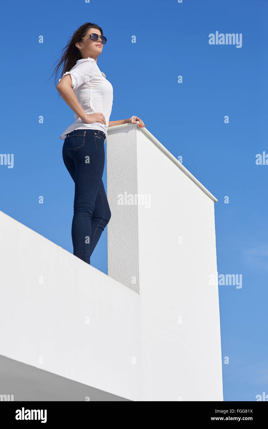 relaxed woman in front of luxury modern home Stock Photo - Alamy