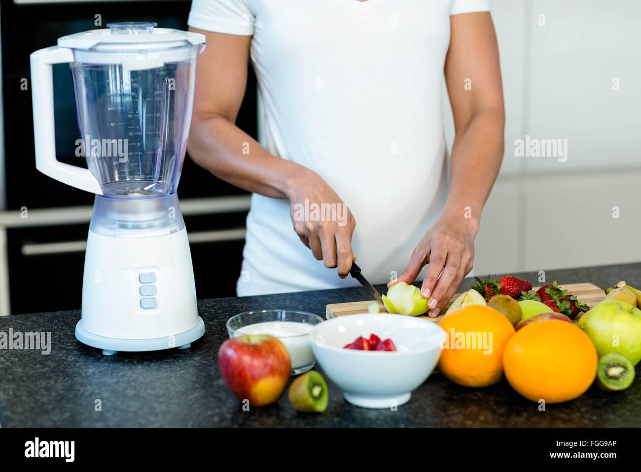 Pregnant woman cutting fruits Stock Photo Alamy