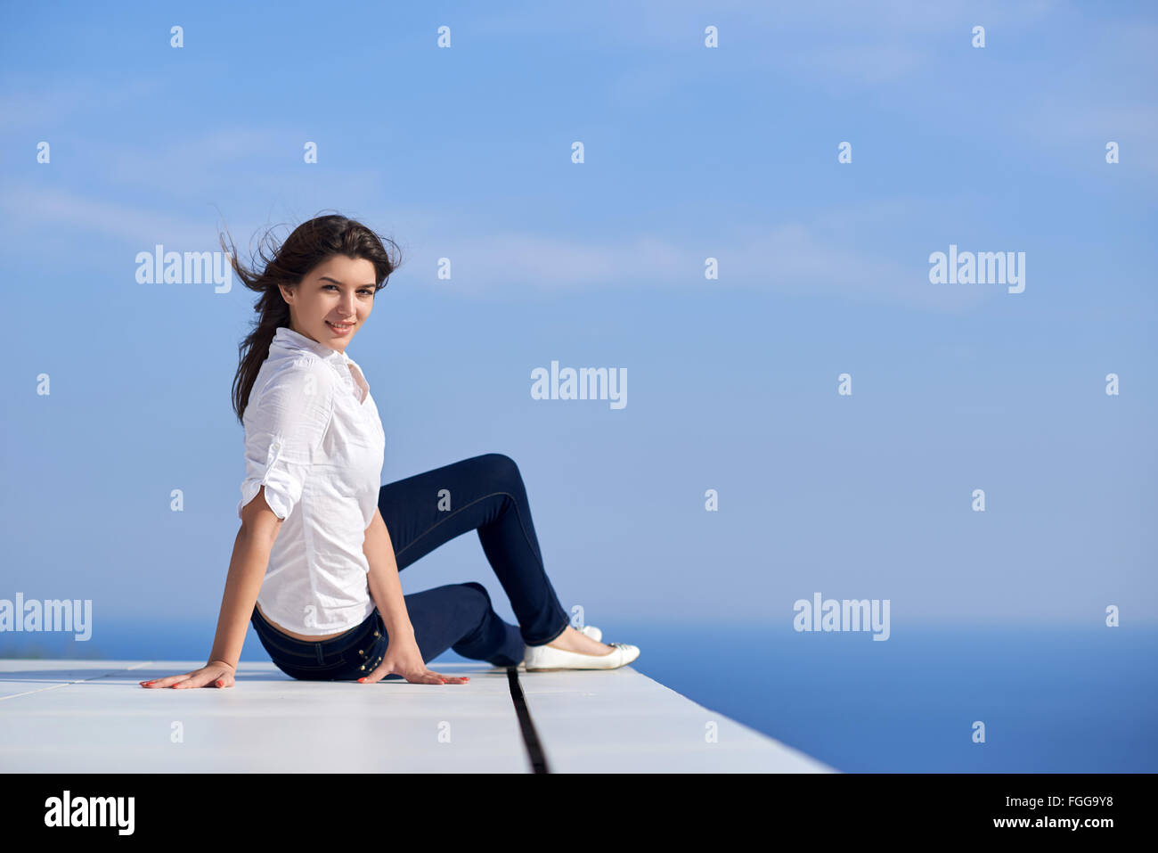 relaxed woman in front of luxury modern home Stock Photo - Alamy