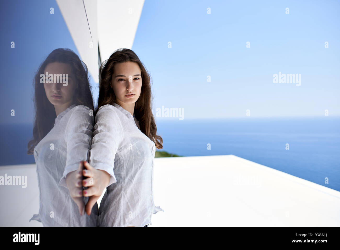 relaxed woman in front of luxury modern home Stock Photo - Alamy