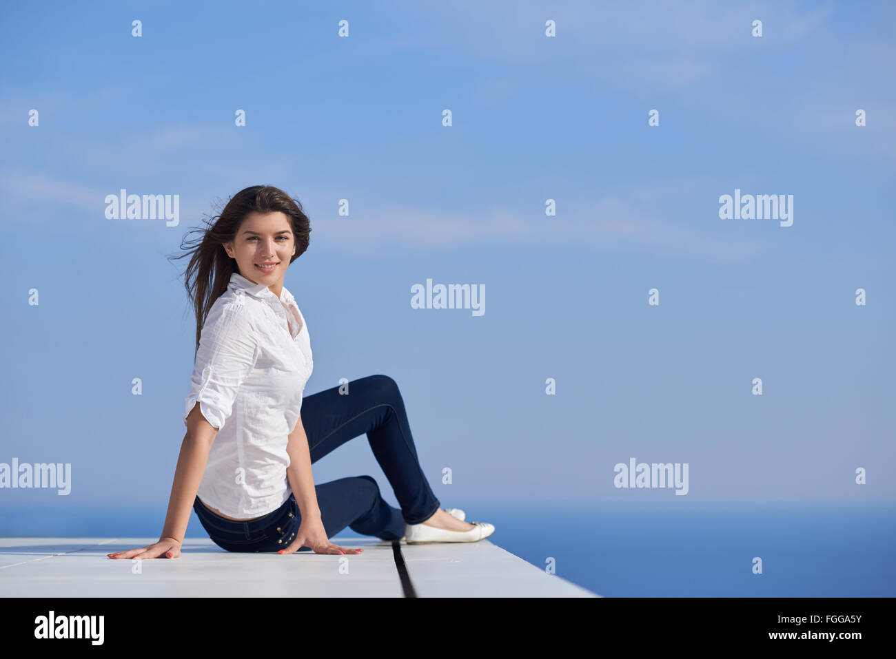 relaxed woman in front of luxury modern home Stock Photo - Alamy